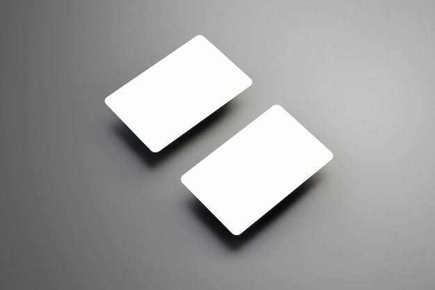 Zdjęcie realistyczne białe dwie karty bankowe z cieniami na szarym tle.