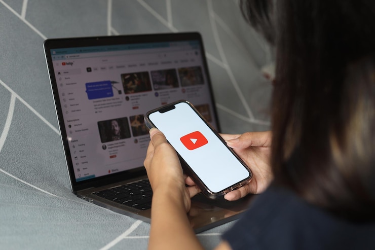 Zdjęcie ręce kobiety trzymające smartfon z aplikacjami youtube na ekranie. youtube jest popularny w internecie