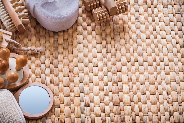 Zdjęcie ręcznie szklane drewniane szczotki do masażu i miękkie gąbki do kąpieli na wiklinowej koncepcji sauny w tle