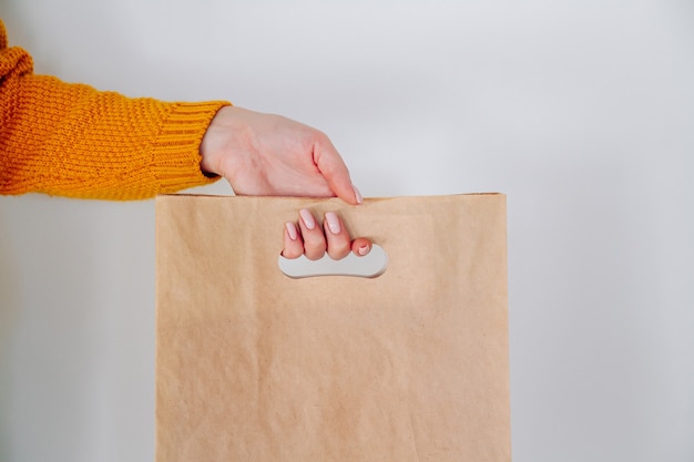 Zdjęcie ręka dostawy z papierową torbą na zakupy