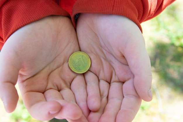 Ręka trzyma monety euro na ulicy