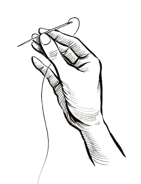 Zdjęcie ręka z igłą i nitką. czarno-biały rysunek tuszem