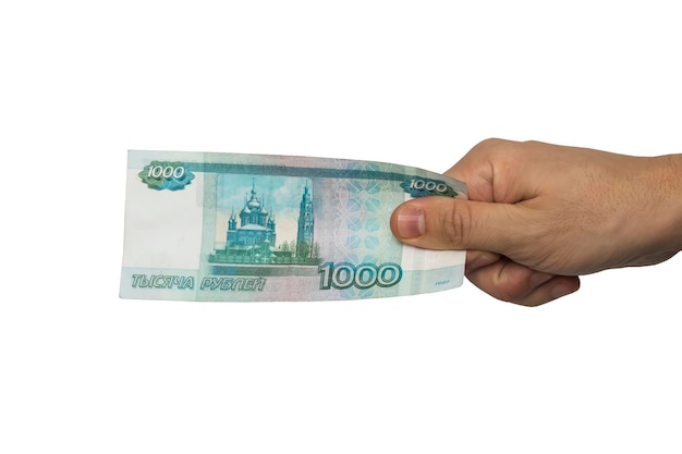 Ręka z rosyjskimi pieniędzmi na białym tle tysiąc rubli w ręku