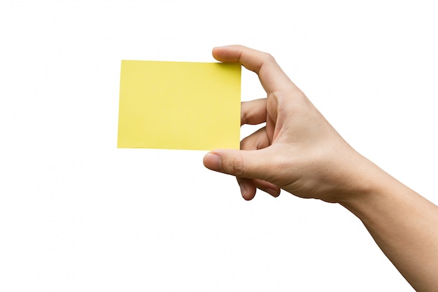 Ręki mienia koloru żółtego papier odizolowywający na bielu z ścinek ścieżką.