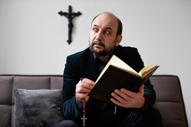 Zdjęcie religijny mężczyzna czytający świętą księgę w domu