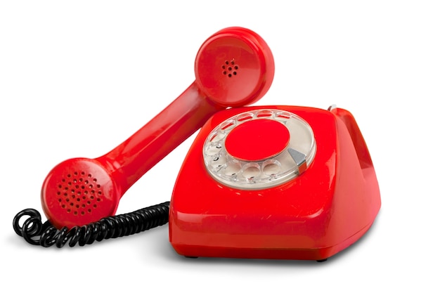 Retro czerwony telefon na białym tle