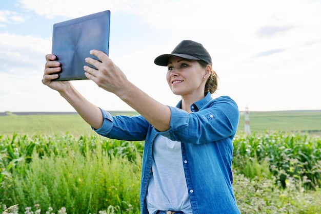 Rolnictwo rolne, kobieta agronom rolnik pracujący z cyfrowym tabletem w polu kukurydzy, analizuje zbiory.