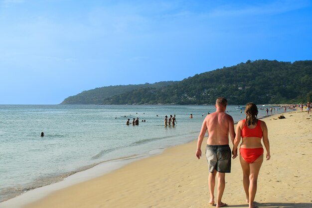 Romantyczna dojrzała para spacerująca po plaży na wakacjach