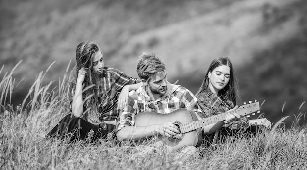 Romantyczny piknik w turystyce piosenki przy ognisku grupa ludzi spędza razem wolny czas rodzina na kempingu piesze wycieczki przygoda szczęśliwi mężczyźni i dziewczyny przyjaciele z gitarą przyjaźń Czuję się komfortowo