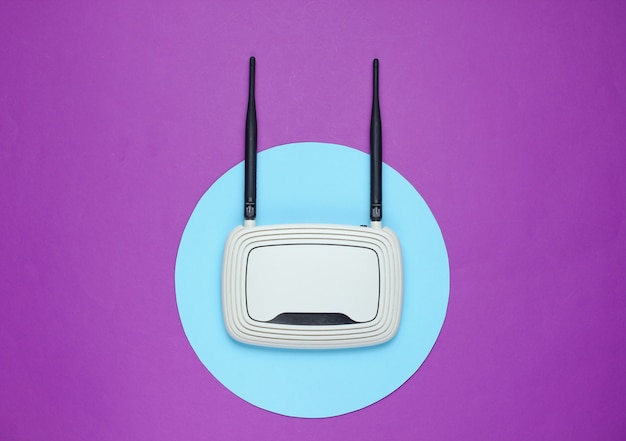 Router Wi-Fi w kolorze fioletowym z niebieskim kółkiem pośrodku