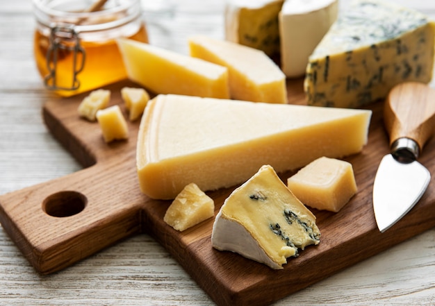 Różne rodzaje sera na białej drewnianej powierzchni