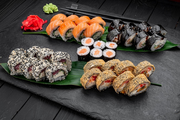 Różne sushi nigiri i maki duży zestaw na łupku Różnorodne japońskie sushi z tuńczykiem, łososiem, węgorzem i bułeczkami