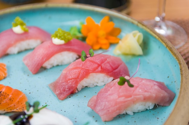 Różne sushi premium nigiri z tuńczykiem i łososiem na pięknie udekorowanym talerzu