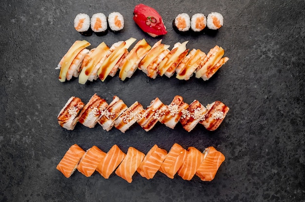Różne zestawy sushi nigiri i rolki sushi na kamiennym tle