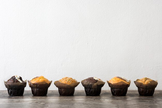Różnorodność muffins na drewnianej stole kopii przestrzeni