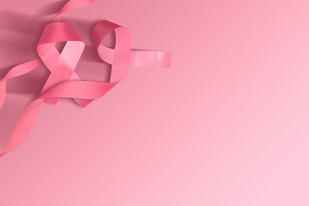Zdjęcie różowa wstążka świadomości na kolorowym tle
