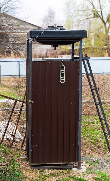 Zdjęcie rural homemade outdoor shower for gardening and farming