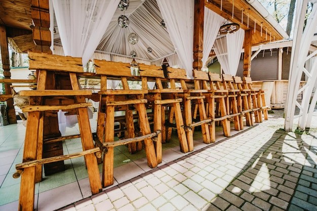 Rząd wysokich drewnianych krzeseł barowych