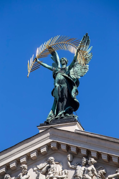 Rzeźba z brązu geniusz ze złotą gałązką palmową i skrzydłami na dachu Teatru Opery i Baletu we Lwowie
