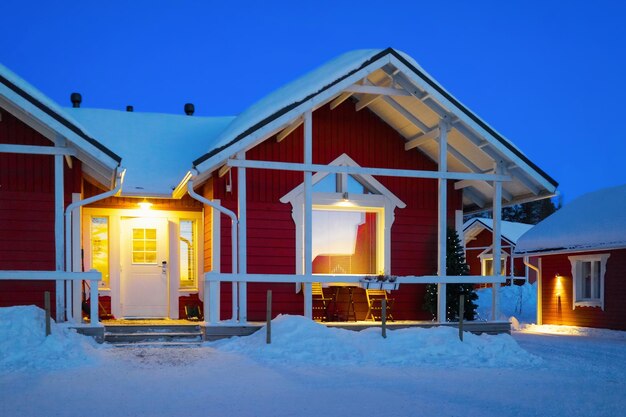 Santa Claus Holiday Village Houses, Laponia, Finlandia, na kole podbiegunowym w zimie. Po zachodzie słońca