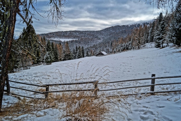 Zdjęcie sceniczny widok pokrytego śniegiem pola i wzgórz na tle nieba