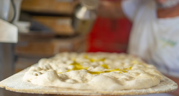 Selektywne skupienie się na zbliżeniu tradycyjnej rzymskiej pizzy gotowej do pieczenia