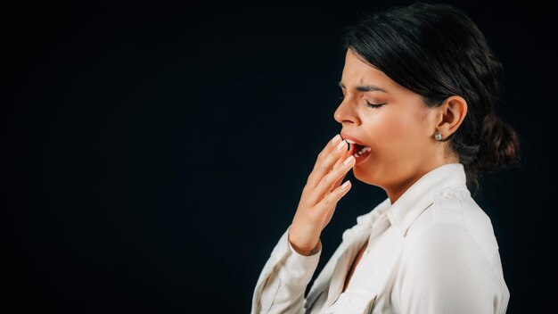 Senność Młoda zmęczona kobieta czuje się senny portret studyjny czarne tło