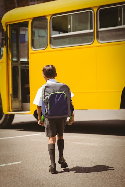 Śliczny uczeń chodzi autobus szkolny