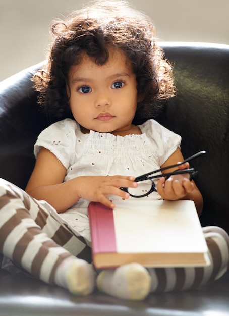 Zdjęcie słodka dziewczyna z pamiętnikiem siedząca na krześle.