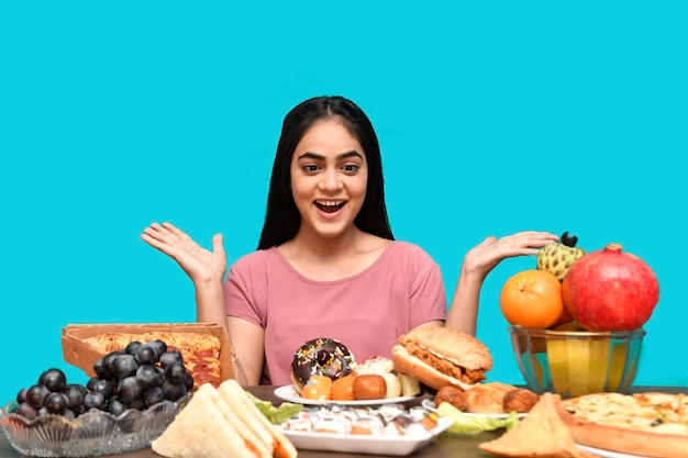 smakosz dziewczyna siedząca przy stole z owocami i czująca się szczęśliwa indyjska modelka pakistańska