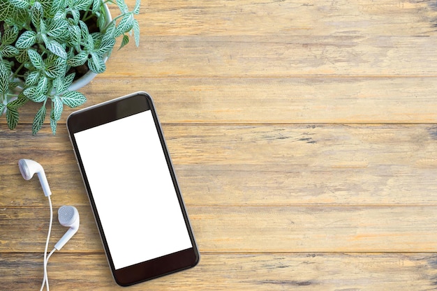 Smartfon biały ekran biały telefon ucha i na tle drewnianego stołu