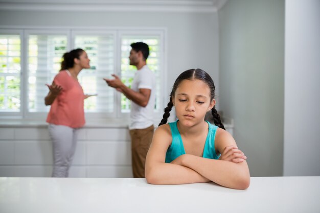 Smutna dziewczyna słucha kłótni rodziców