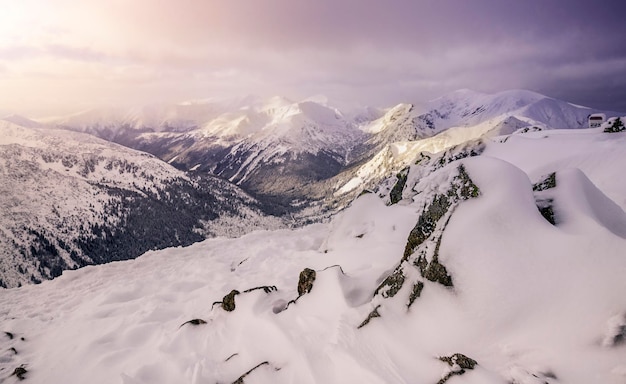 Śnieżne góry z niskimi białymi chmurami wschód słońca zakopane polska