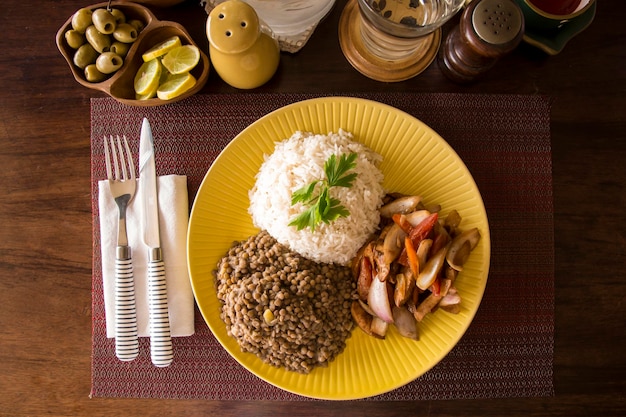 Soczewica smażony kurczak ryż peruwiański tradycyjne jedzenie mise en place drewniany stół