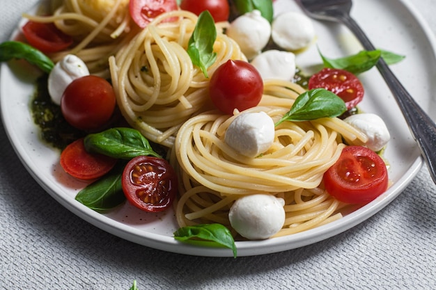 Spaghetti z mozzarellą, pomidorami, bazylią i sosem pesto, makaron Caprese