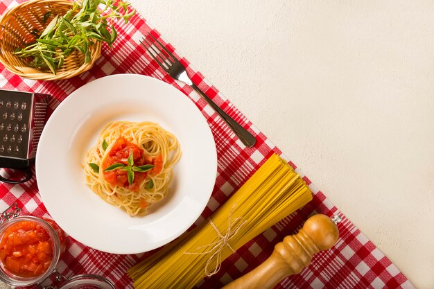 Spaghetti z sosem pomidorowym i bazylią na rustykalnym drewnianym tle