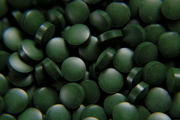 Spirulina zielone pigułki tło Spirulina algi zielone tabletkisuper foodsuplementy diety z wodorostami