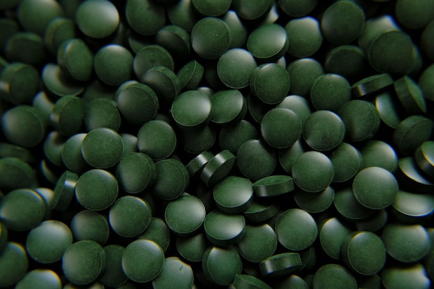 Spirulina zielone pigułki tło Spirulina algi zielone tabletkisuper suplementy diety dla zdrowego stylu życia