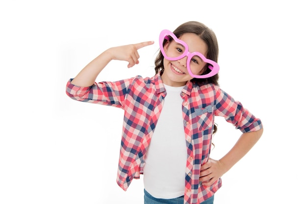 Sprawdź mój styl Dziecko szczęśliwe śliczne nosi śliczne okulary akcesoria Dziecko czarujące uśmiech odizolowany białe tło Dziewczyna okulary w kształcie serca świętuje walentynki Dziewczyna wskazujące serce okulary