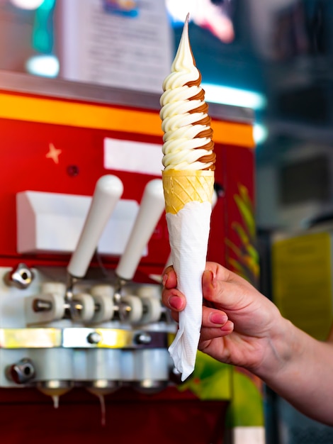 Sprzedawca podaje lody w filiżance waflowej