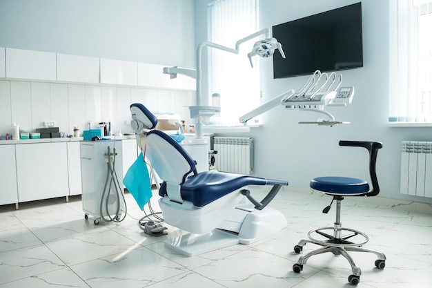 Zdjęcie sprzęt stomatologiczny w gabinecie stomatologicznym w nowym pokoju nowoczesnej kliniki stomatologicznej tło fotela dentystycznego i akcesoriów