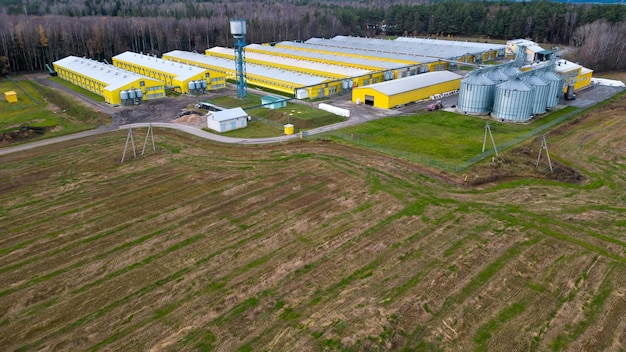 Srebrne silosy na agrozakładzie produkcyjnym do przetwórstwa suszenie czyszczenie i przechowywanie produktów rolnych mąka zboża i zboże Latanie dronem nad żelaznymi beczkami z ziarnem quadcopter photo