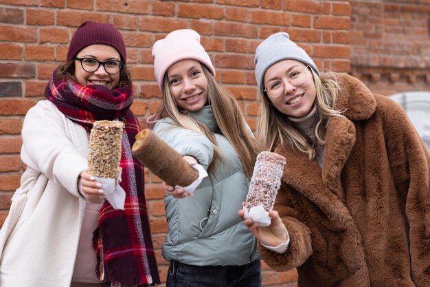 Średnio ujęcia kobiety pozujące z ciastami z komina