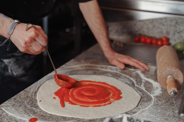 Środkowa część mężczyzny przygotowującego pizzę