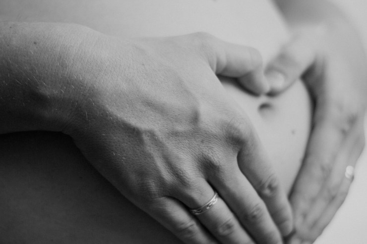 Zdjęcie środkowa sekcja ciężarnej kobiety dotykającej brzucha