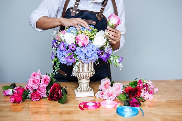 Zdjęcie Środkowa sekcja kwiaciarni aranżująca kwiaty na stole w sklepie
