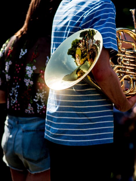 Zdjęcie Środkowa sekcja mężczyzny trzymającego instrument muzyczny przez kobietę