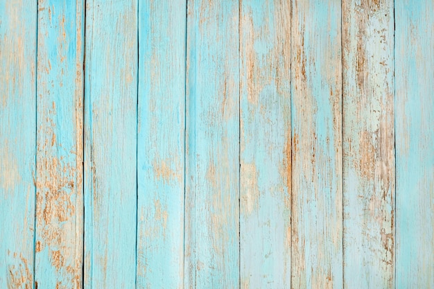 Stara wyblakła drewniana deska pomalowana na turkusowo-pastelowy kolor.
