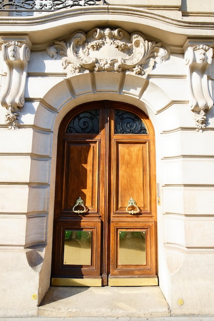 Stare ozdobne drzwi w typowym starym budynku mieszkalnym w Paryżu