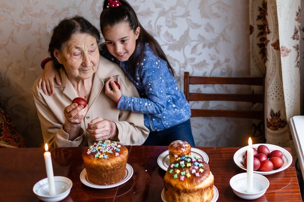 starsza kobieta z pisanki i wielkanocny tort.